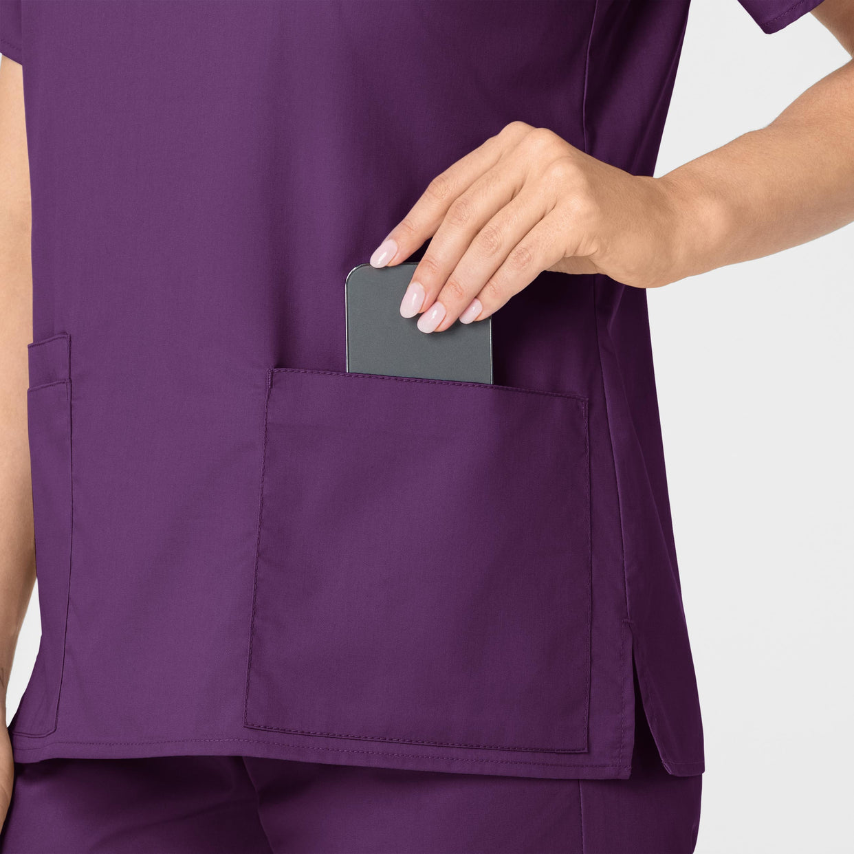 WonderWORK Women's V-Neck Scrub Top Eggplant hemline detail