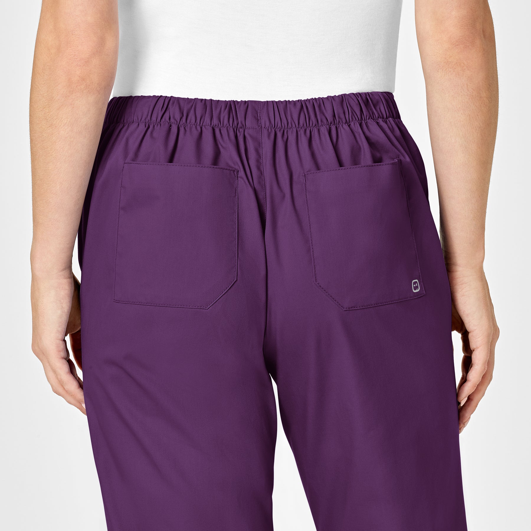 WonderWORK Women's Flare Leg Scrub Pant Eggplant hemline detail