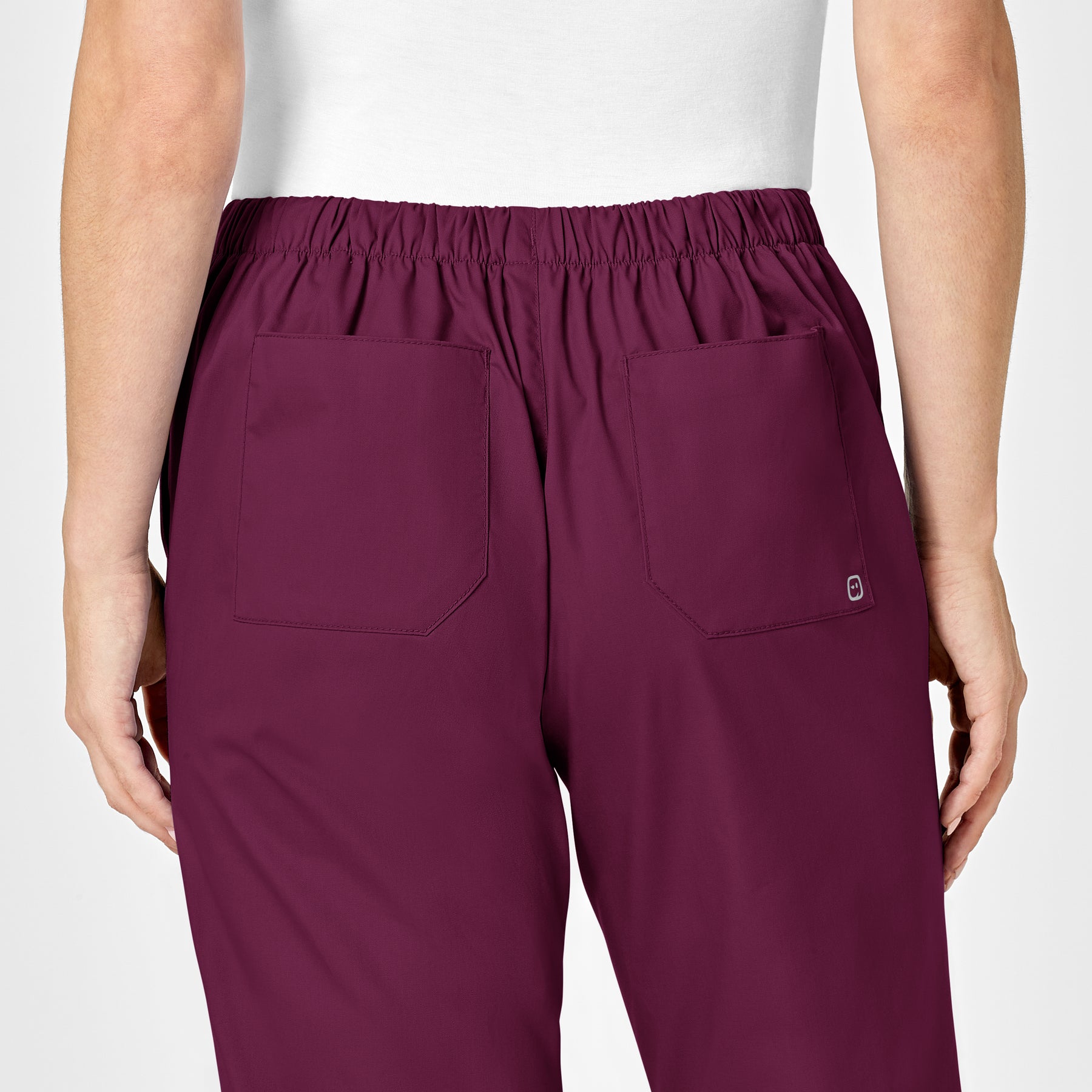 WonderWORK Women's Flare Leg Scrub Pant Wine hemline detail