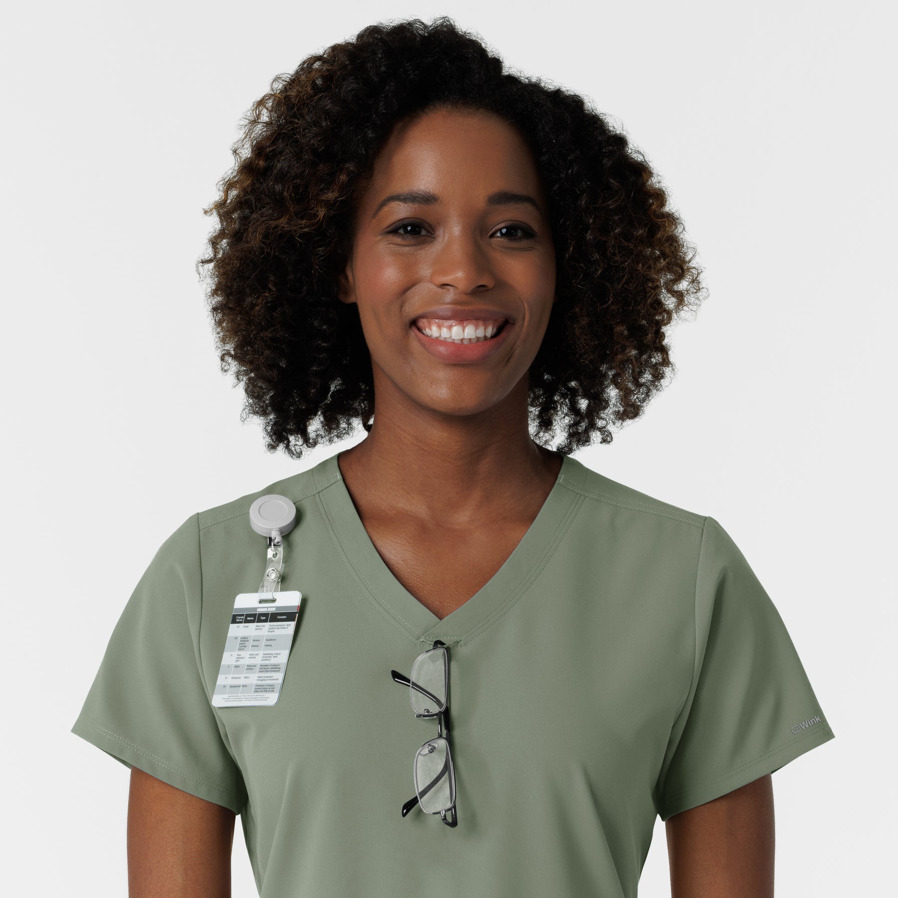 NURTUR Women's V-Neck Scrub Top - Sage badge and glasses loop