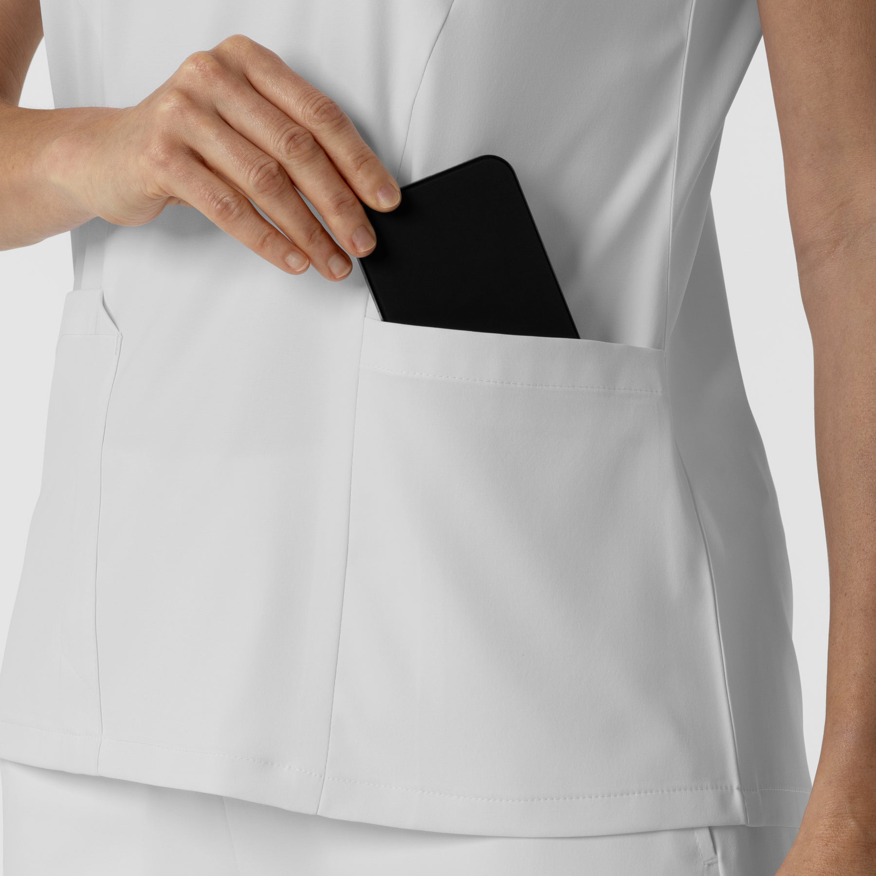 Boundless Women's 2-Pocket V-Neck Scrub Top White hemline detail