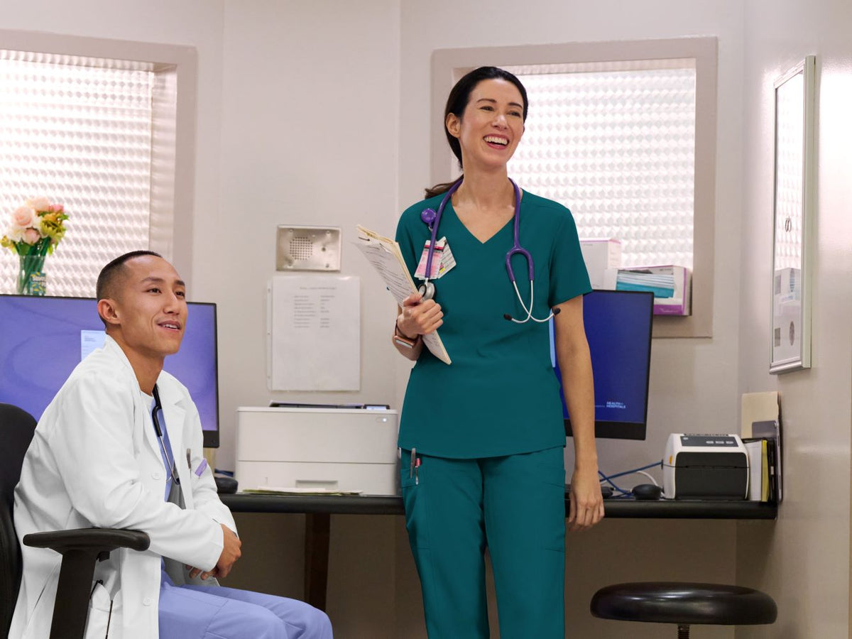 Two healthcare professionals in a medical office setting.
