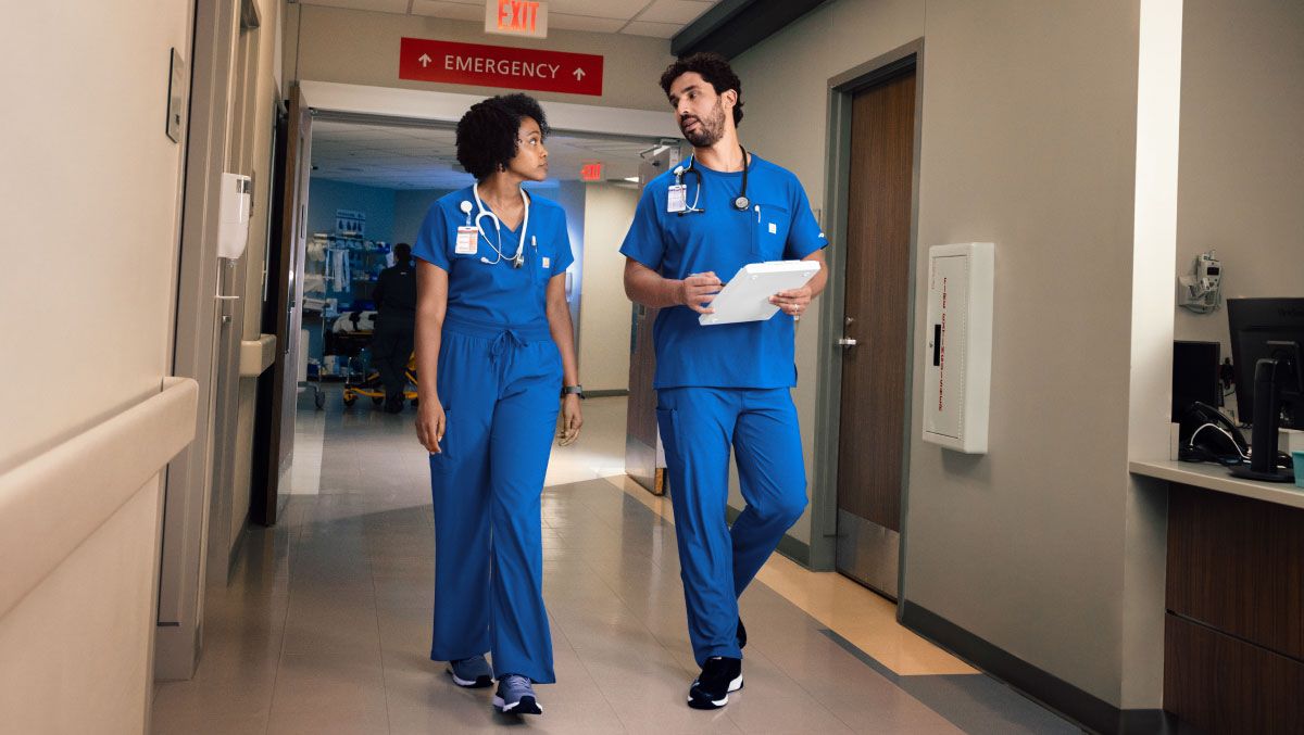 man and woman in carhartt royal blue scrubs