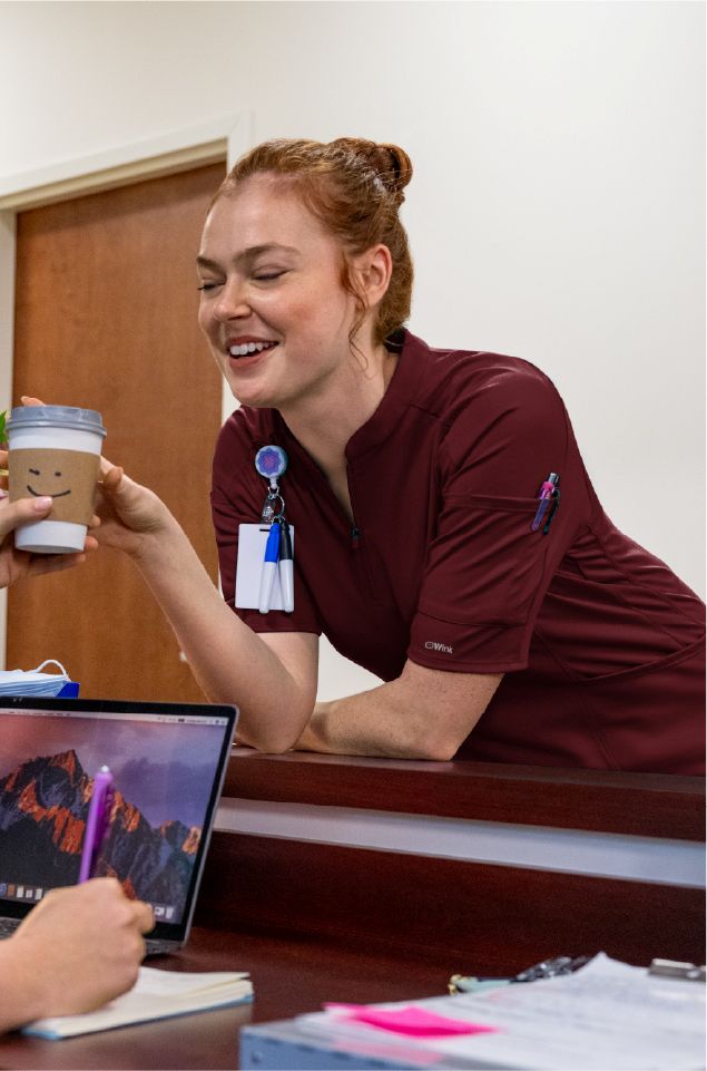 woman in renew knits burgundy scrubs