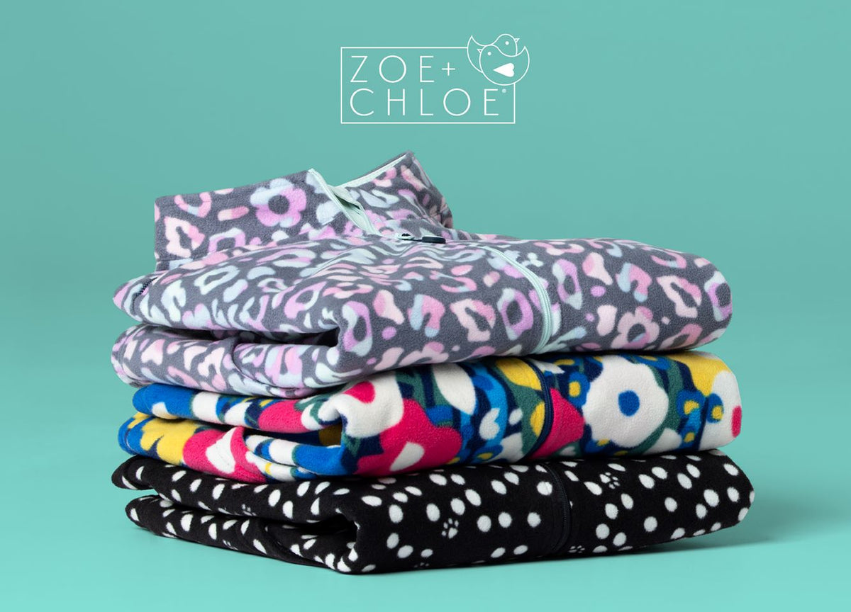 Stack of printed fleece jackets. Boxy fit fashion fleece jackets. Zoe+Chloe logo in white