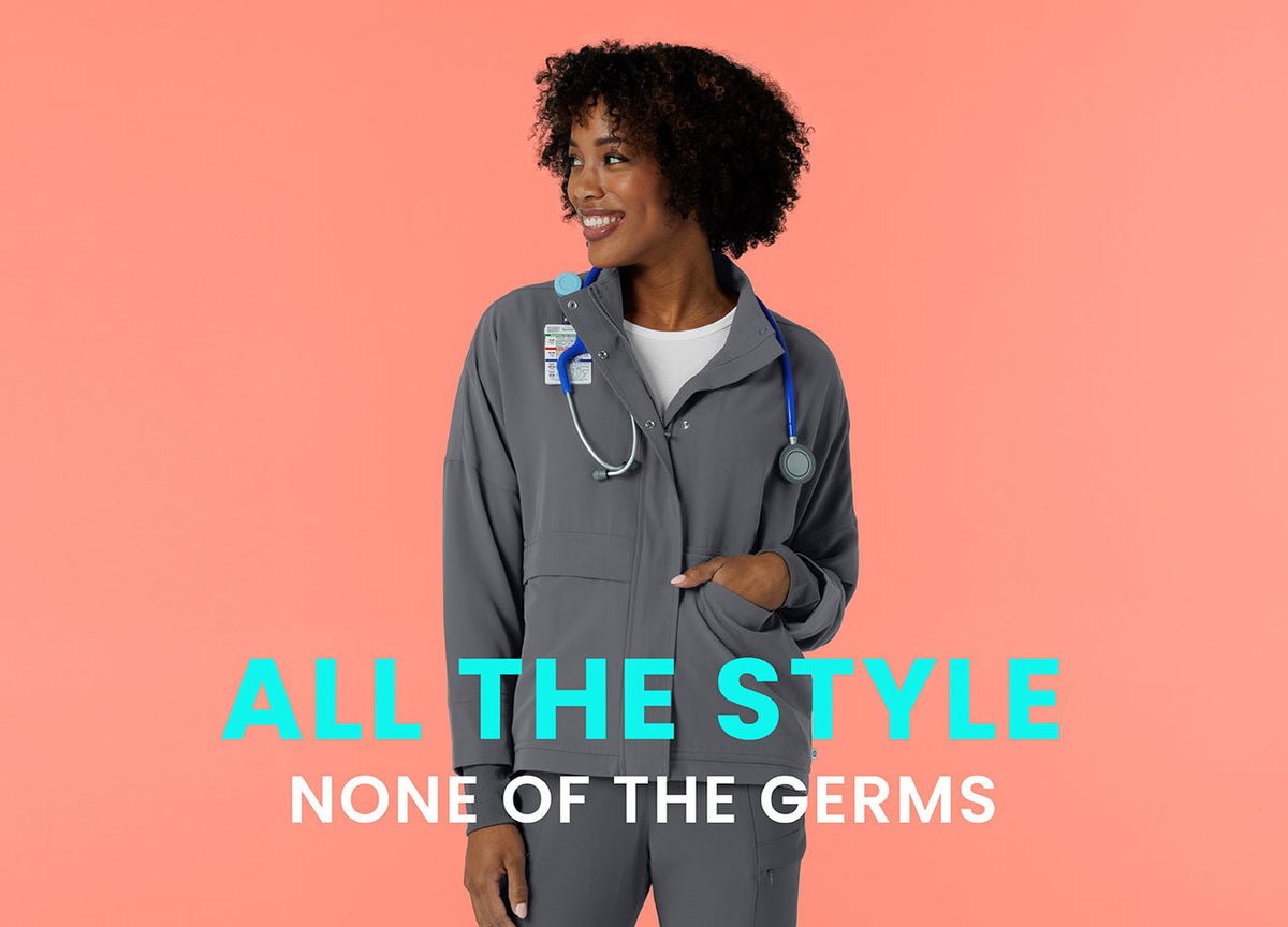 "All the style none of the germs" text over woman in the new Wink packable scrub jacket in Pewter.
