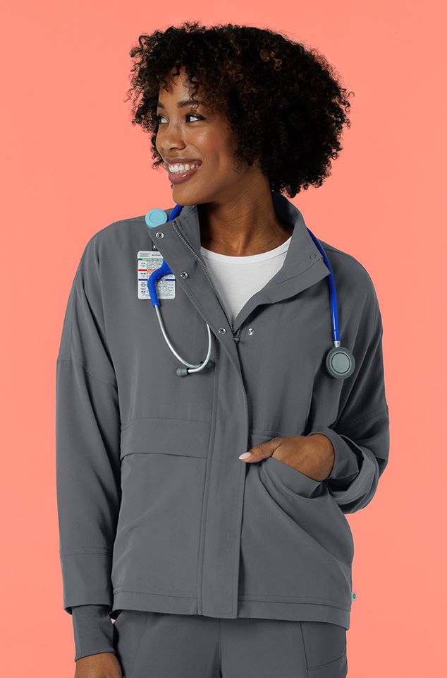 Woman in Germs Happen packable scrub jacket. Wear it in, fold it up and pack it out!