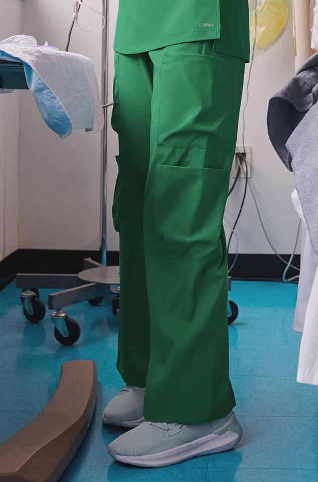 wide leg scrub pants in hunter green and red rotating in a video