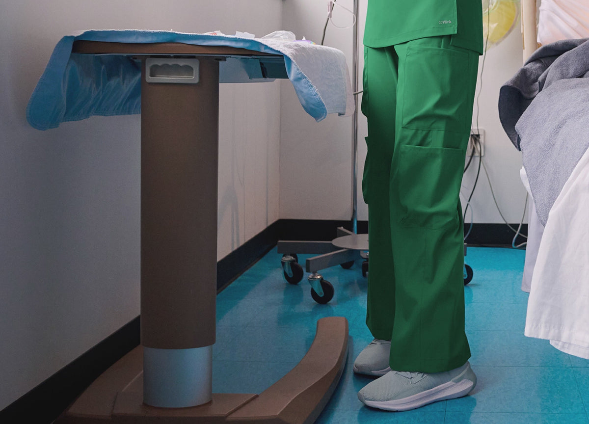 wide leg scrub pants in hunter green and red rotating in a video