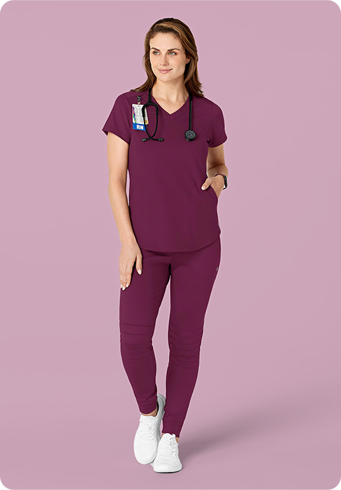 Woman in wine v-neck scrub top and wine jogger scrub pants